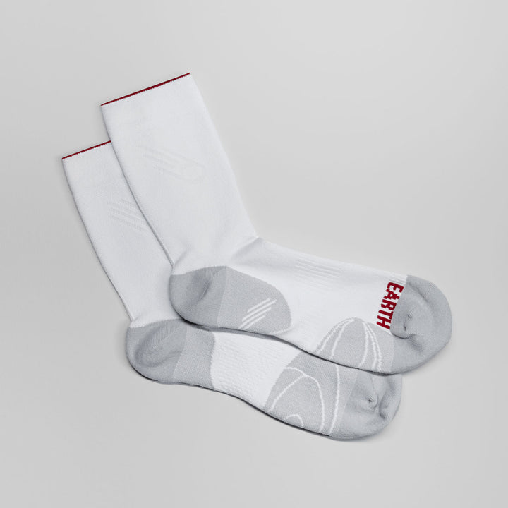 White running socks with "Earth" text, designed for breathability and cushioning.